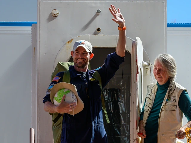 Linda Leigh (right), one of the original Biosphere 2 crew members, opens the door for Matthias Beach as he exits the Space Analog to the Moon and Mars habitat.